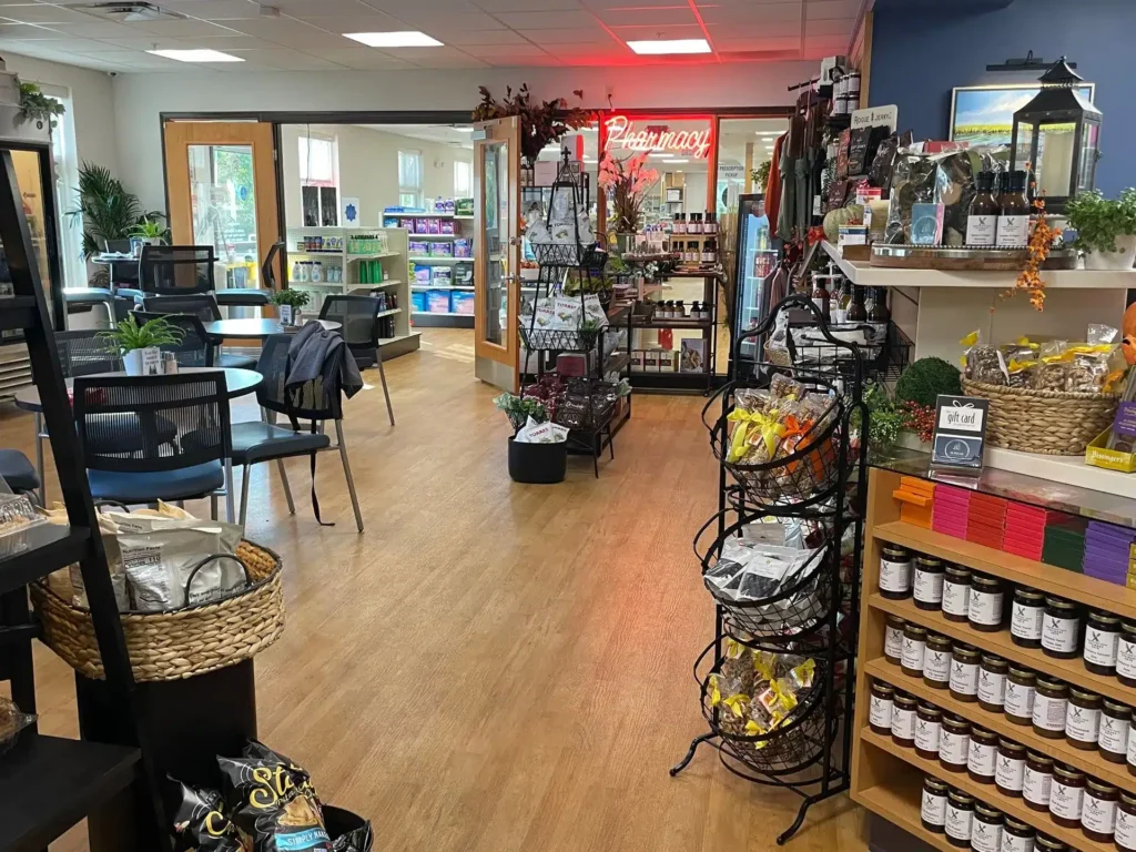 The cafe has a seating area and leads to a pharmacy.