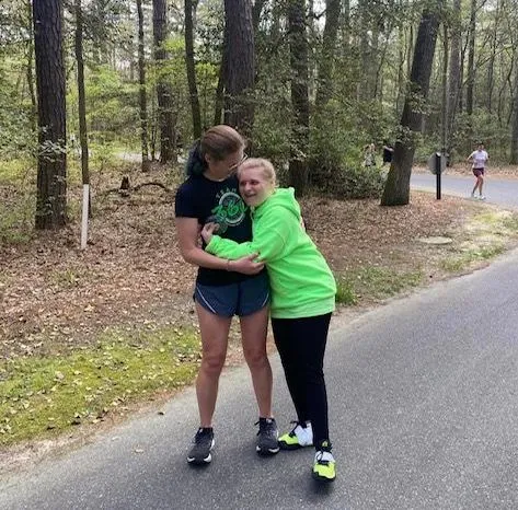 Claire helps athlete Kayleen Kascuta mid-run. If athletes are able, they can walk part of a course, whether it